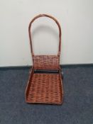 A wicker and metal log trolley