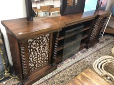 An early Victorian rosewood inverted breakfront sideboard with barley twist column supports fitted