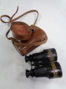 A pair of WWI binoculars in brown leather case