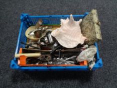 A basket of large shell, plated cutlery and napkin rings,