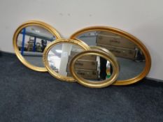 Four gilt framed oval mirrors