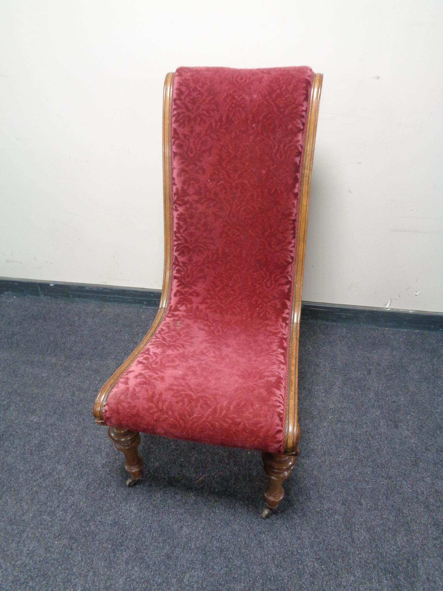 An antique mahogany framed nursing chair