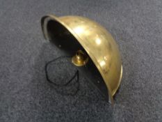 A brass bowl wall light