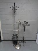 A chrome metal gent's valet stand together with a metal floor standing five way candle holder and a
