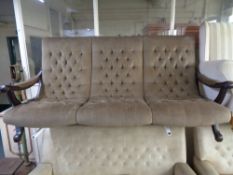A twentieth century brown buttoned dralon three seater settee on X-framed support