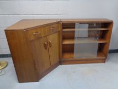A mid 20th century teak twin section corner bookcase