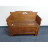 An oak Arts & Crafts storage hall seat