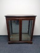 A reproduction mahogany double door bookcase