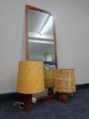 A mid 20th century teak framed mirror and three further mid 20th century teak table lamps with