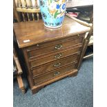 A mahogany Regency style four drawer chest with slide