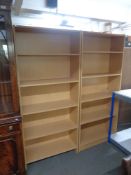 A pair of contemporary office open bookshelves in a pine finish