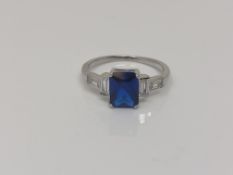 An Art Deco style Sterling silver ring set with a blue stone, size N.