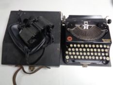 A cased Remington portable typewriter and a pair of Titan 8 x 30 field glasses