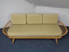 An Ercol solid elm and beech three seater studio couch, catalogue no.