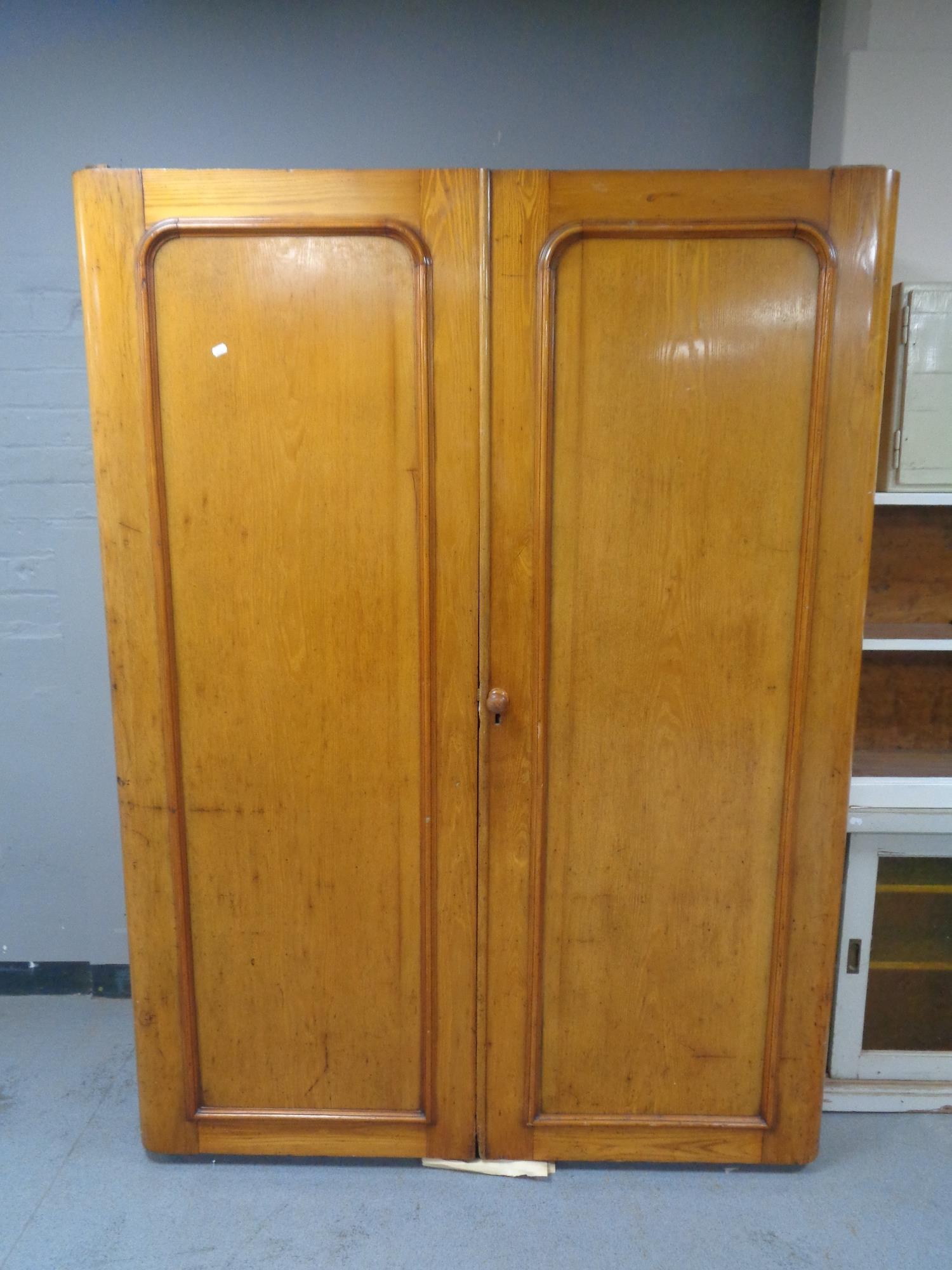 A Victorian double door gentleman's wardrobe fitted internal trays and shelves,