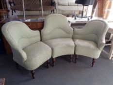 An early twentieth century three section shaped back settee on turned mahogany legs