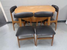 A late 20th century teak kitchen table and four chairs