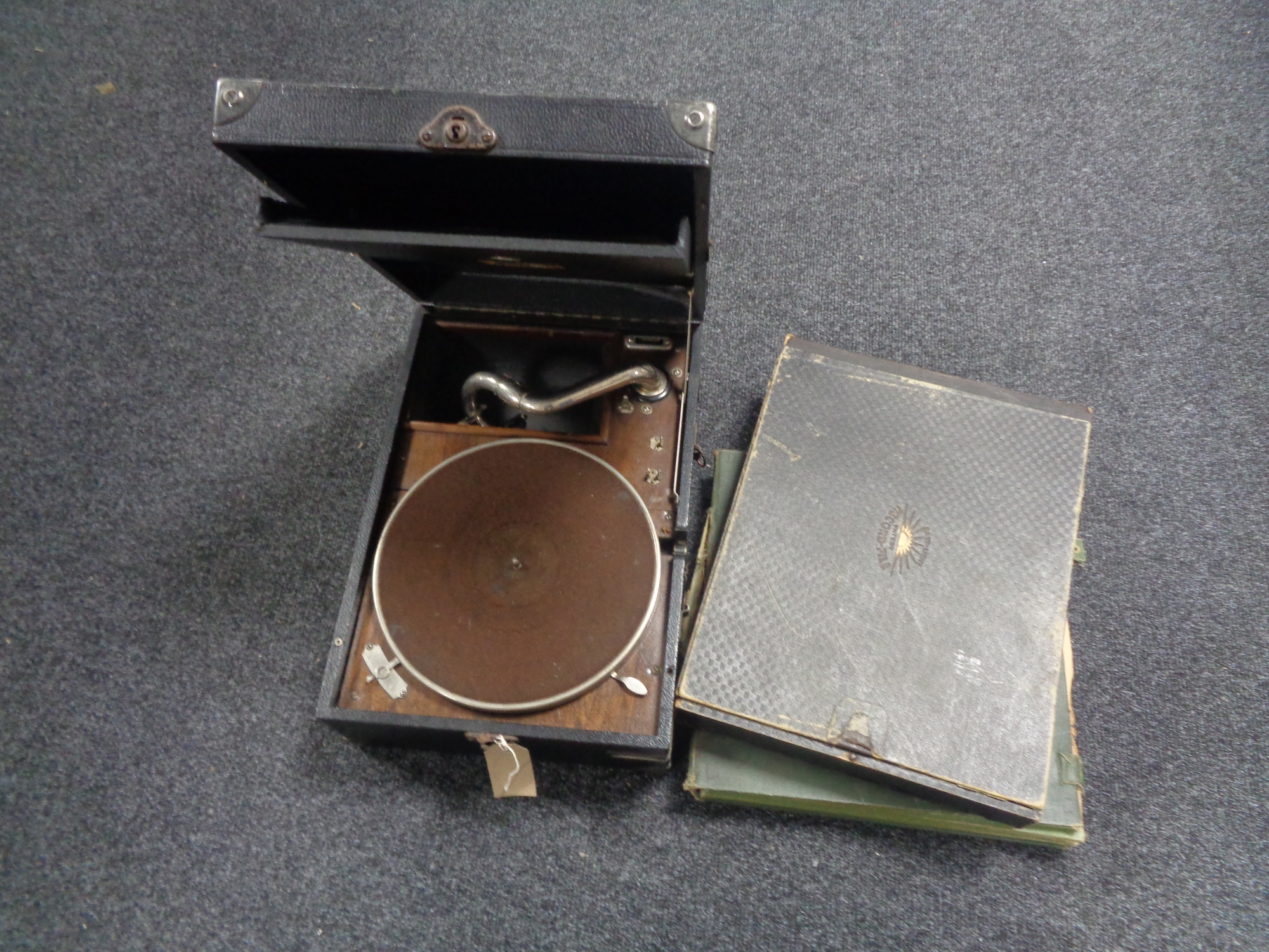 A 20th century table top portable HMV gramophone together with two cases of 78's
