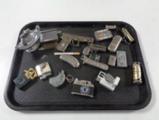 A tray of a collection of novelty lighters