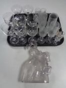 A tray of antique and later drinking glasses, a clear glass decanter,