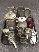 A tray of eleven assorted pieces of antique pewter ware, tankards, measures,