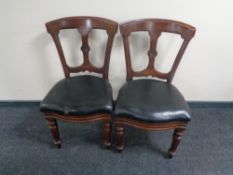 A pair of antique mahogany black leather seated dining chairs