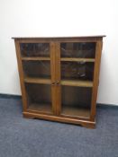 An oak effect double door glazed bookcase