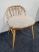 An Ercol solid elm and beech dressing table chair