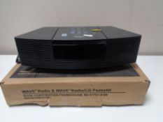 A Bose Wave radio CD player with remote,