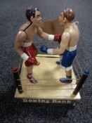 A cast iron money box modelled as a boxer