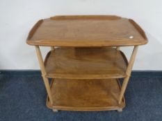 An Ercol solid elm and beech three tier trolley, catalogue no.