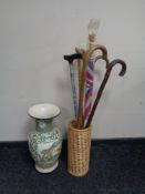A glazed Chinese pottery vase depicting a dragon together with a stick stand containing an umbrella