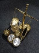 A tray of assorted brass ware, ship's style clock and barometer, balance scales,