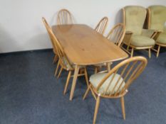 An Ercol solid elm and beech dining table, catalogue no.