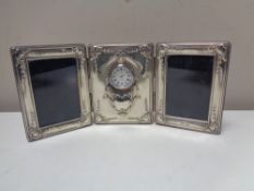 A silver framed triple photograph frame with clock central panel CONDITION REPORT: