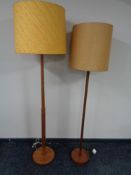 Two mid 20th century (Ercol?) teak standard lamps with shades