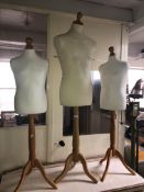 Three dress makers mannequins on stands