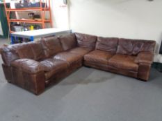 A five seater brown leather corner settee