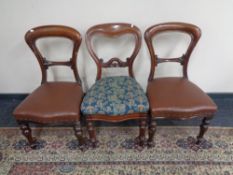A set of four Victorian mahogany dining chairs in leatherette upholstery together with two similar
