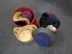 Two red velvet hat boxes containing lady's hats