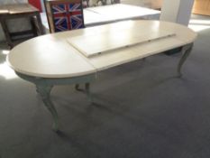 An antique continental painted extending dining table with three leaves on cabriole legs