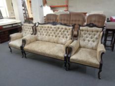 A three piece Edwardian mahogany framed lounge suite upholstered in floral tapestry covering