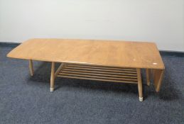 An Ercol elm and beech flap-sided coffee table with undershelf, length 104cm, 160cm extended,