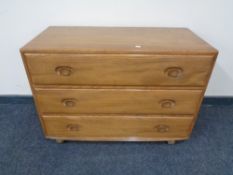 An Ercol solid elm three drawer chest, catalogue no.