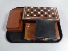 A tray of five cased travel game sets