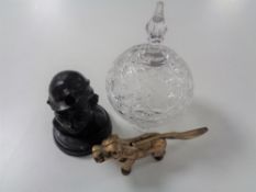 A vintage brass nut cracker in the form of a dog together with a polished coal figure of a miner