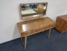 An Ercol solid elm and beech three drawer dressing table, catalogue no.
