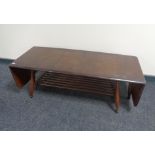 An Ercol stained elm and beech flap sided coffee table with undershelf, catalogue no.