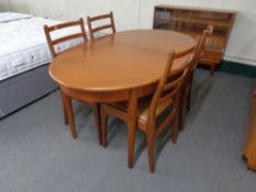A twentieth century oval teak G-plan extending table with four ladder backed chairs