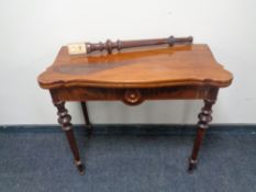 A 19th century shaped mahogany turnover top table (leg a/f)